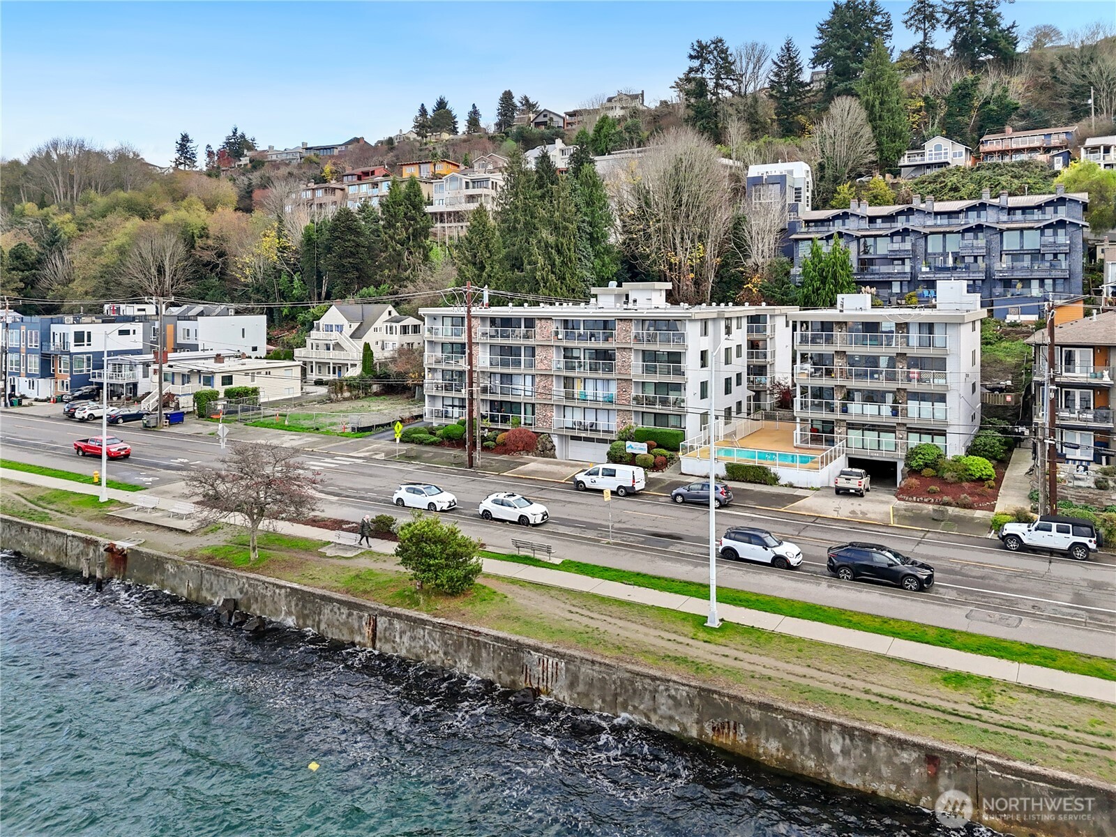 2104 Alki Avenue Southwest, Unit 306 Seattle, WA 98116 - Photo 2 of 40 a view of swimming pool with a patio and a yard