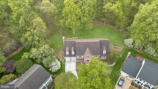 an aerial view of a house with an outdoor space and seating