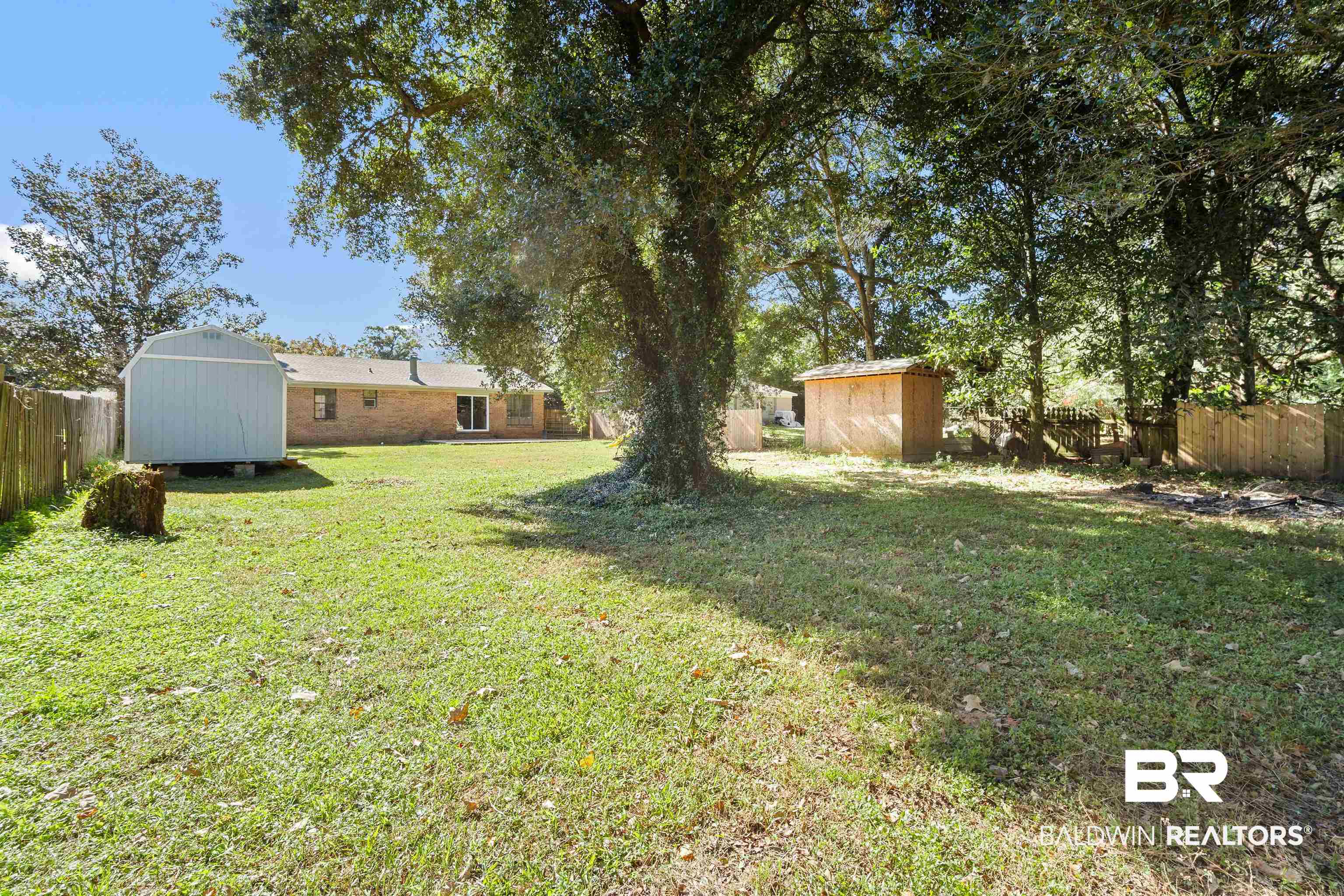 12910 Del Rio Street Grand Bay, AL 36541 - Photo 24 of 26 Fenced backyard featuring a storage shed