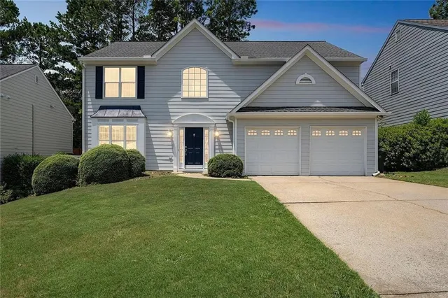 a front view of a house with a yard and garage