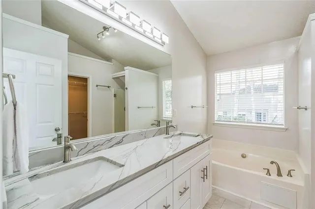 a bathroom with a bathtub and a sink