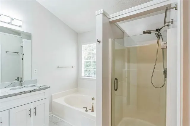 a bathroom with a granite countertop sink a shower and a mirror