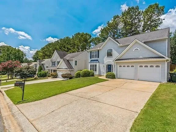 a front view of a house with a yard and garage