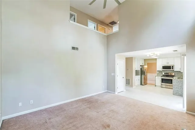 a view of a kitchen with a sink and a refrigerator