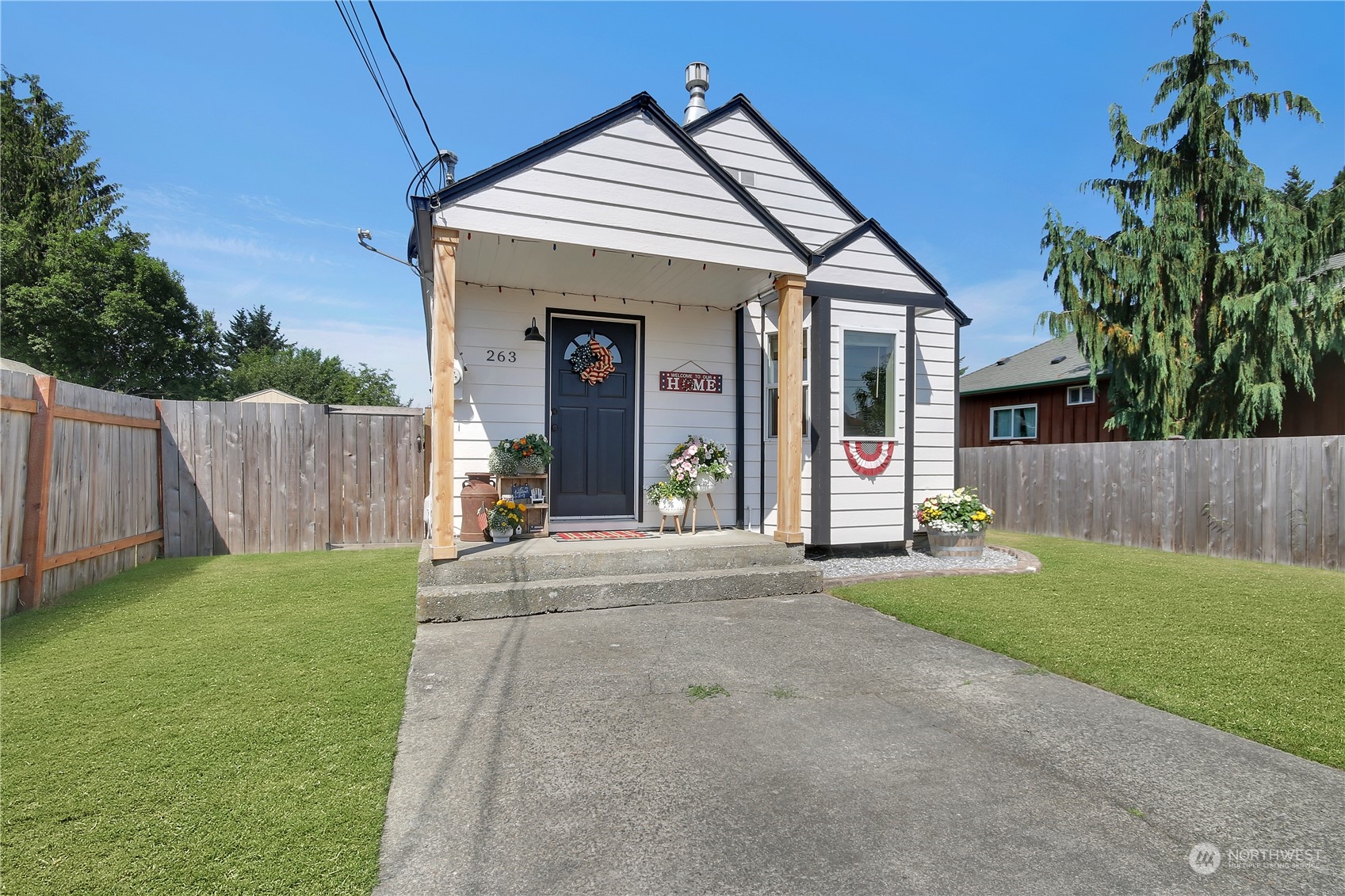 a view of a house with backyard and a tree
