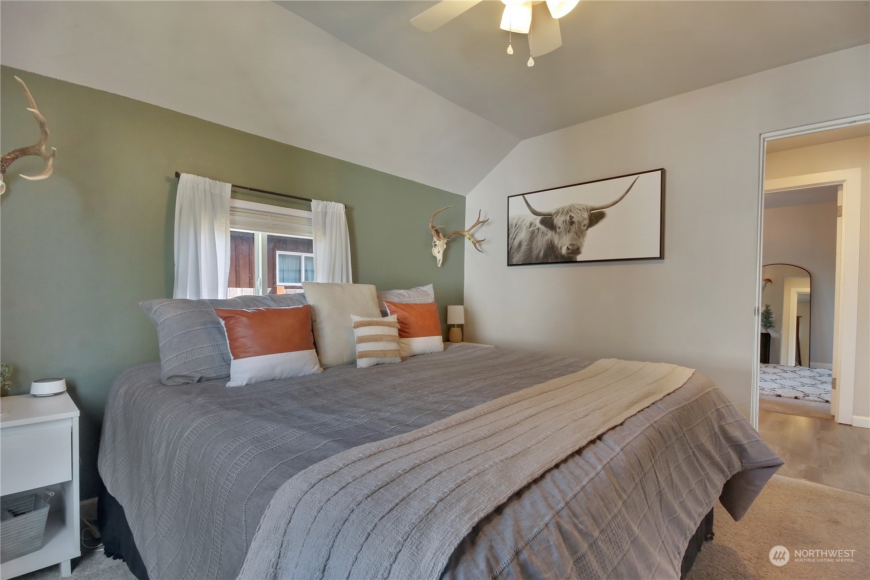 263 Perkins Street Buckley, WA 98321 - Photo 13 of 21 a bedroom with a large bed and a chandelier