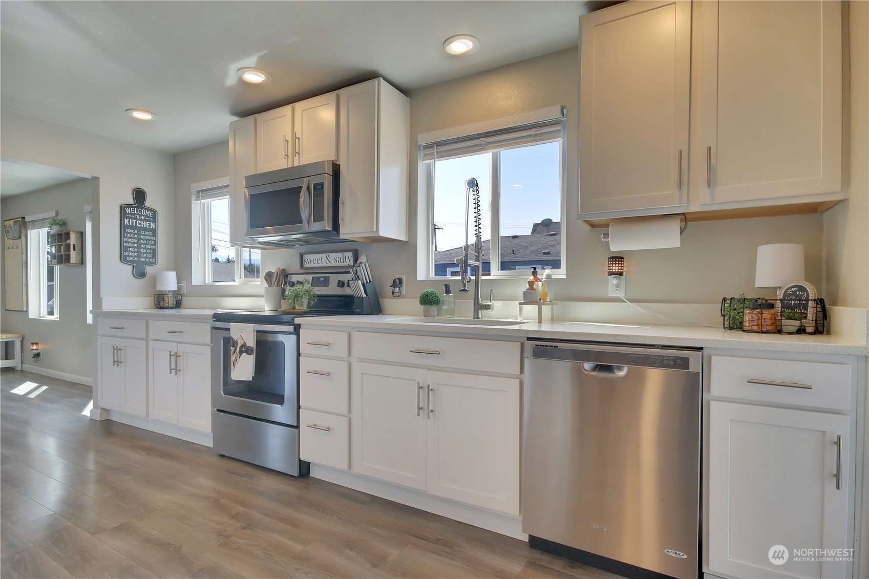 263 Perkins Street Buckley, WA 98321 - Photo 7 of 21 a kitchen with white cabinets white stainless steel appliances and sink
