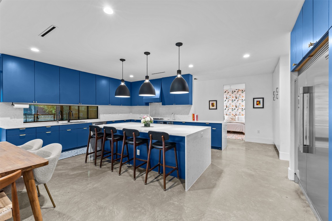 5704 Driftwood Drive Austin, TX 78731 - Photo 11 of 40 a large kitchen with a table and chairs