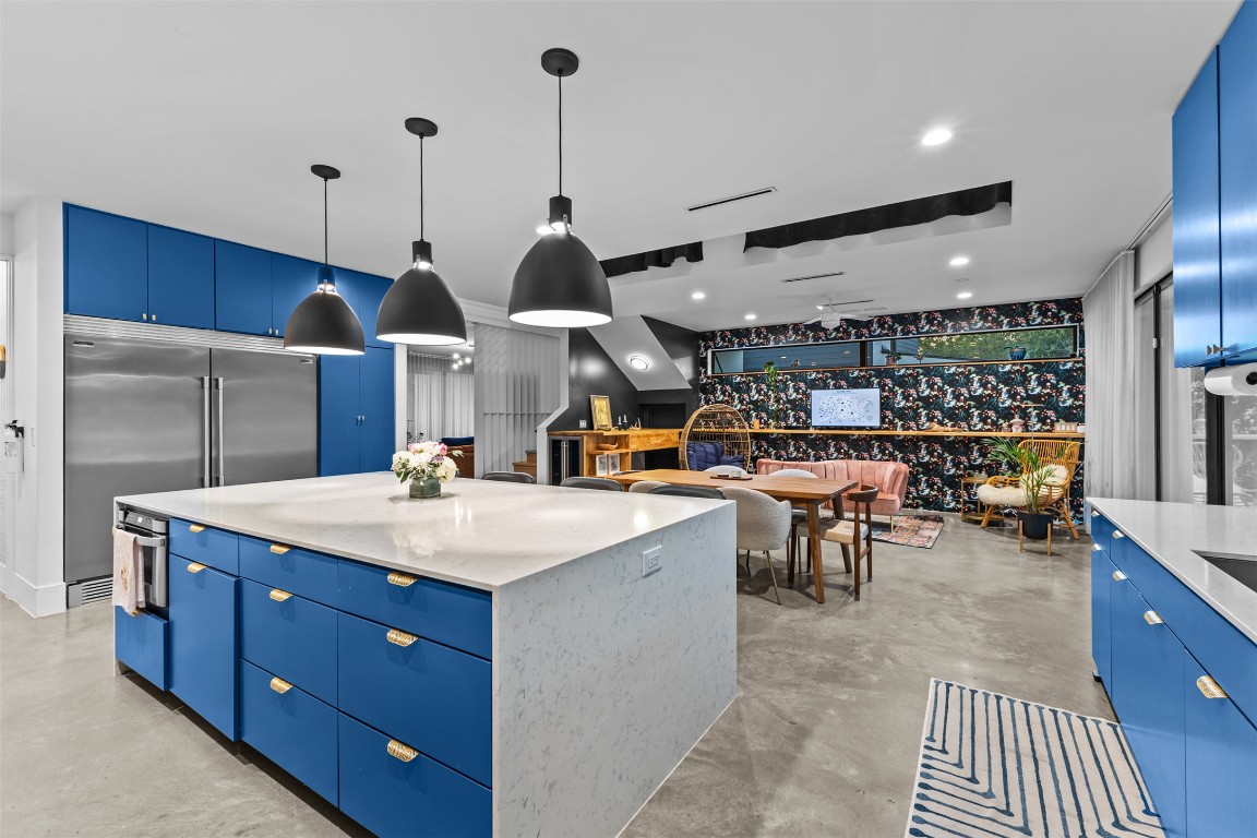 5704 Driftwood Drive Austin, TX 78731 - Photo 13 of 40 a kitchen with stainless steel appliances granite countertop a sink a stove and a wooden floors