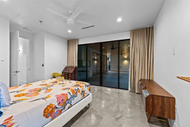 a bedroom with a large bed and a large mirror