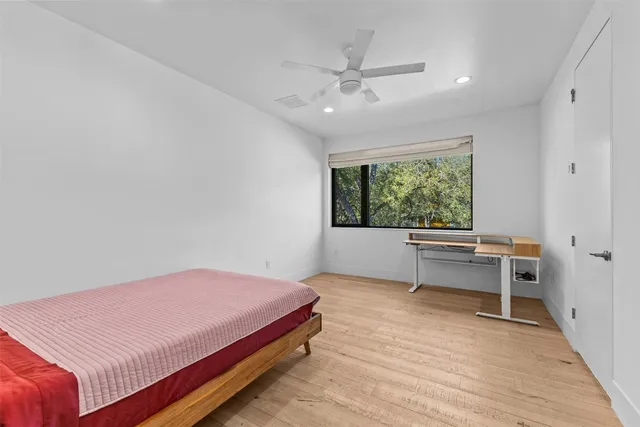 a bedroom with a bed and a couch