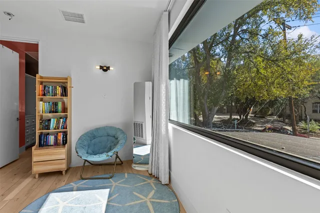 a bedroom with a bed and a mirror