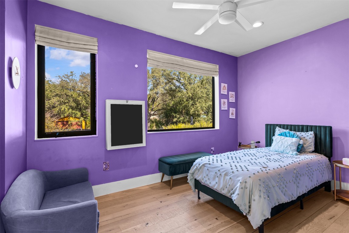 5704 Driftwood Drive Austin, TX 78731 - Photo 27 of 40 a bedroom with a bed and a couch