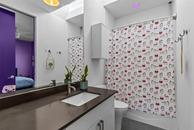 a spacious bedroom with a bed and a dresser