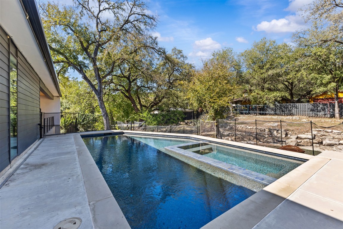 5704 Driftwood Drive Austin, TX 78731 - Photo 33 of 40 a view of a swimming pool with a yard