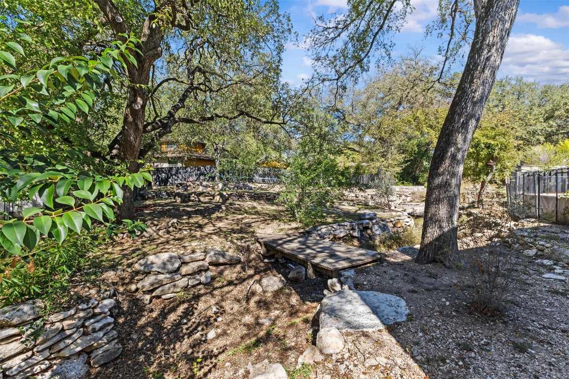 5704 Driftwood Drive Austin, TX 78731 - Photo 34 of 40 a backyard of a house with lots of green space