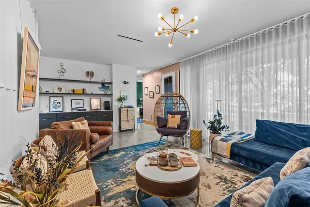 a living room with furniture a rug and a window
