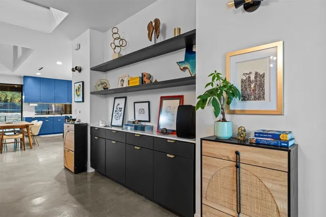 a kitchen with stainless steel appliances granite countertop a sink and a refrigerator
