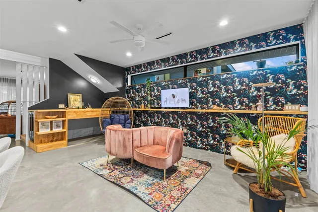 a living room with lots of furniture and plants