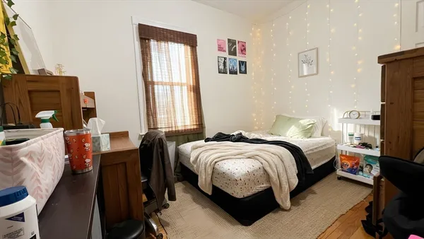 a bedroom with a bed and a window