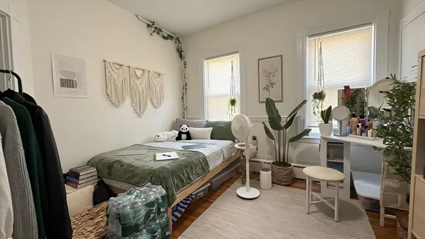 a bed room with a bed and a chair