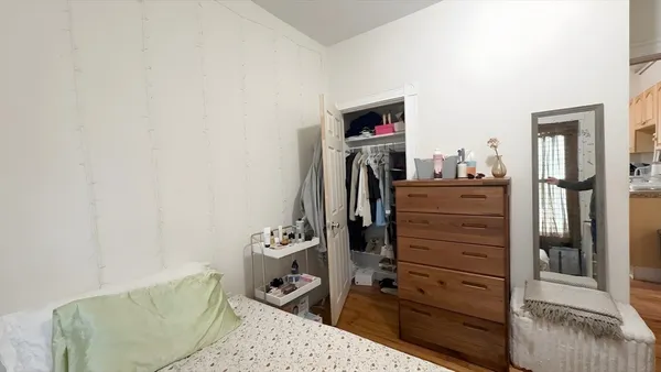 a bed room with a bed and a television