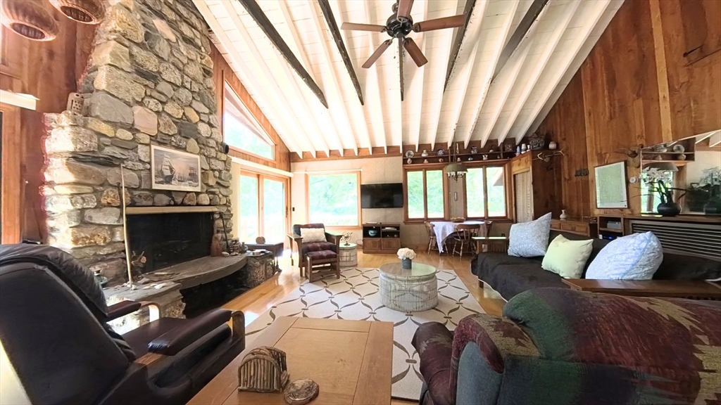 32 Pond Hill Road Goshen, MA 01096 - Photo 9 of 24 a bedroom with furniture a fireplace and large window
