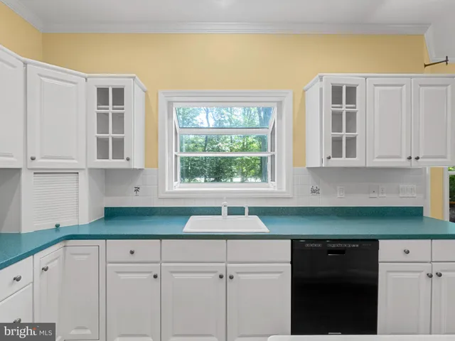 a kitchen with cabinets and window