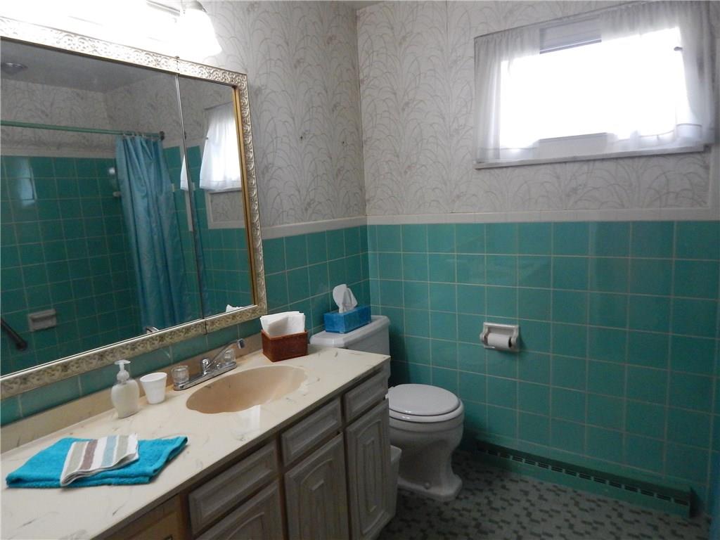 2513 Haymaker Road Monroeville, PA 15146 - Photo 10 of 21 FIRST FLOOR MAIN BATH WITH CERAMIC TILE FLOOR,TUB/SHOWER AND LARGE VANITY SINK.