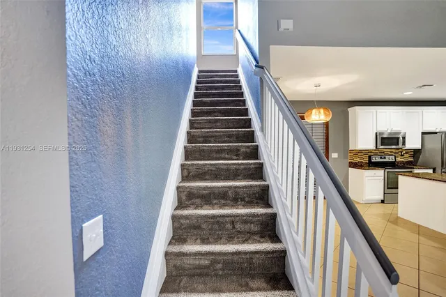 a kitchen with a stove a sink and a refrigerator