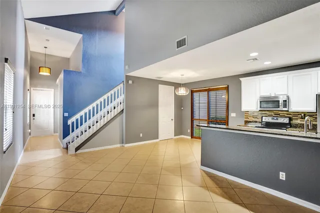 a view of an empty room with a fireplace and a window