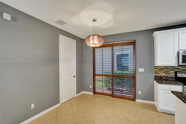 a kitchen with stainless steel appliances granite countertop a sink a stove and microwave