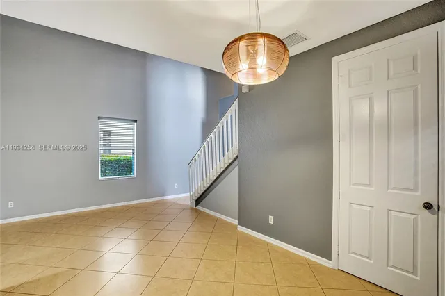 a kitchen with stainless steel appliances granite countertop a sink refrigerator and cabinets