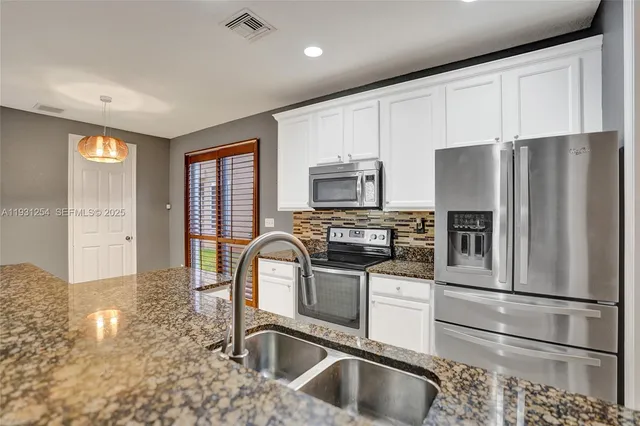a view of a room with wooden floor and a bathroom
