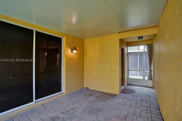 a view of a hallway with wooden floor and closet
