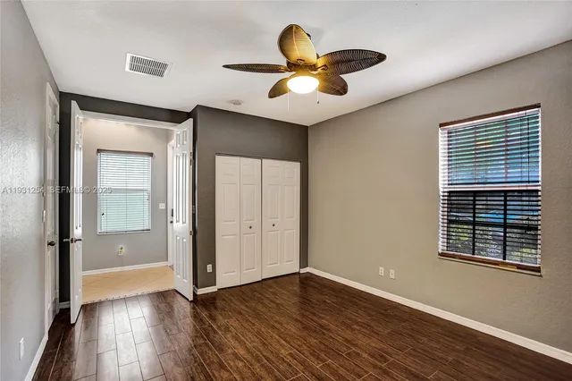 a bathroom with a granite countertop sink and a bathtub