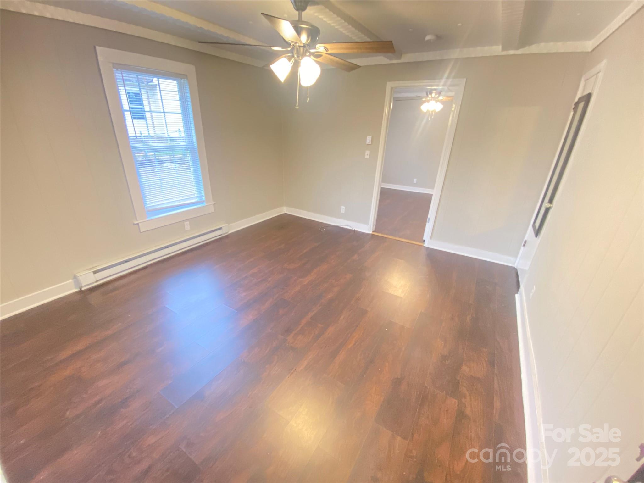 907 Indiana Street Kannapolis, NC 28083 - Photo 3 of 19 an empty room with wooden floor and windows