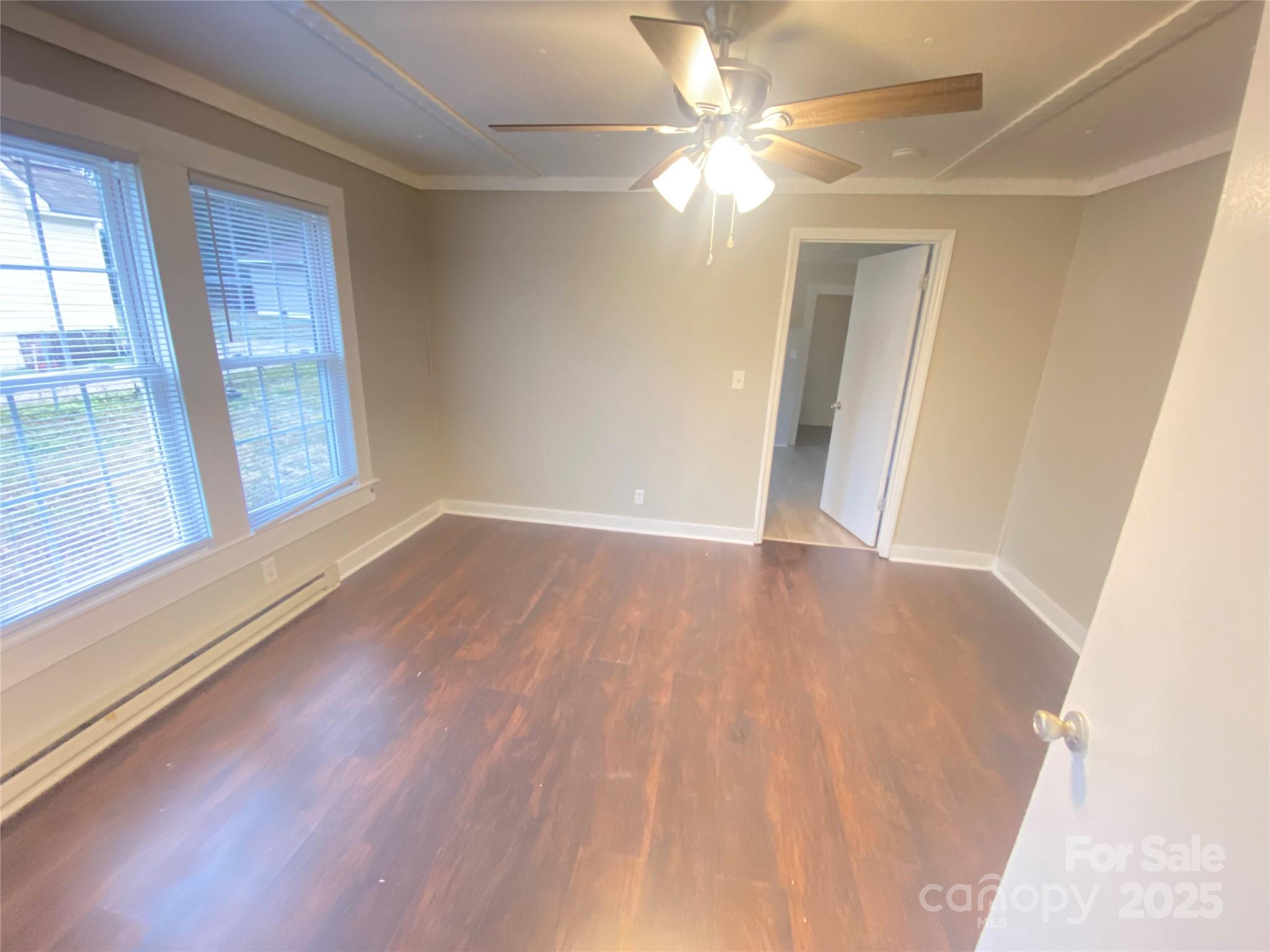 907 Indiana Street Kannapolis, NC 28083 - Photo 4 of 19 wooden floor in an empty room with a window