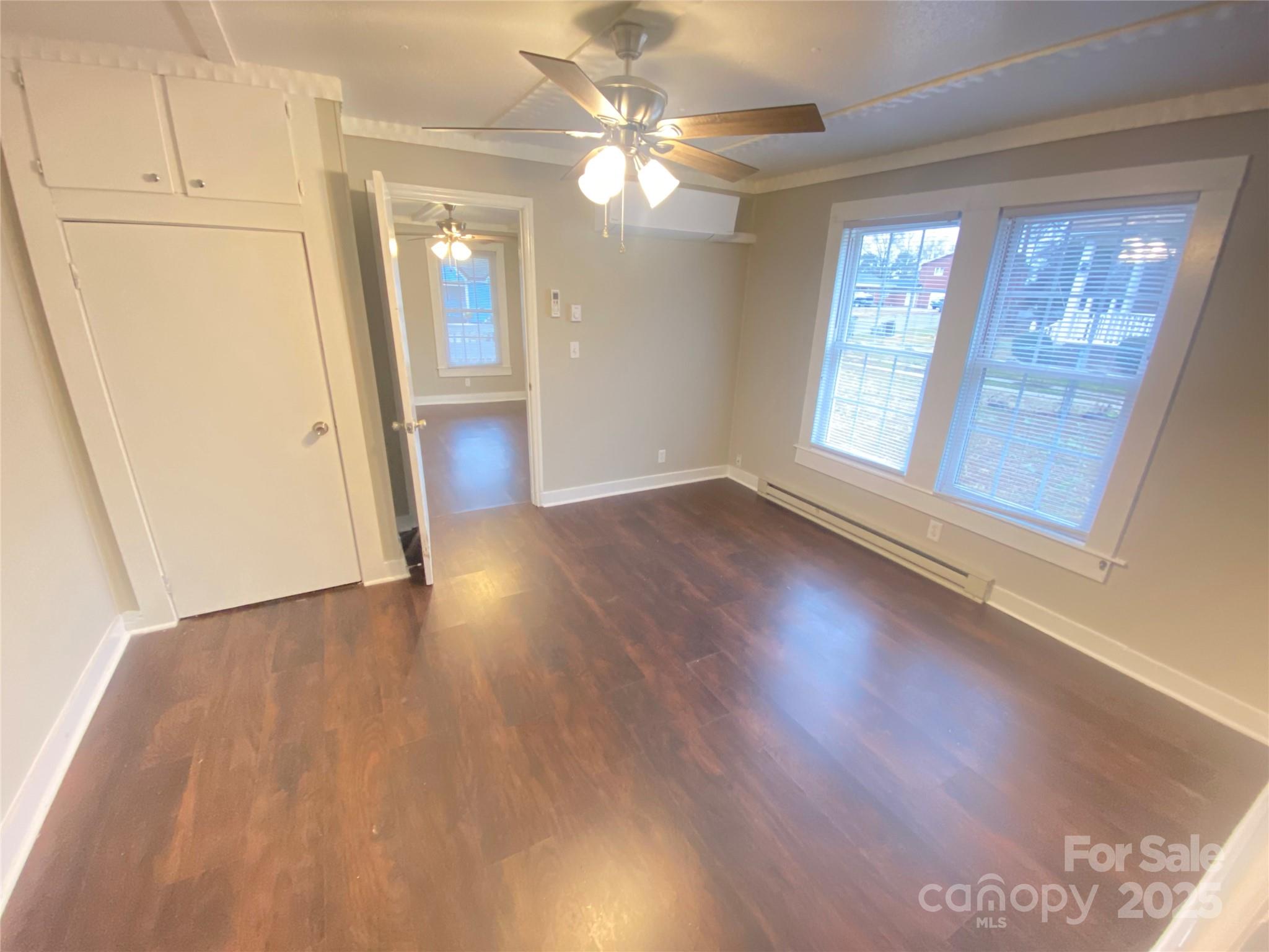 907 Indiana Street Kannapolis, NC 28083 - Photo 5 of 19 an empty room with wooden floor and windows