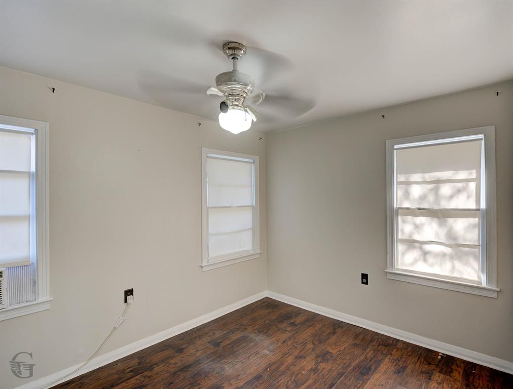 242 Pecan View Drive Minden, LA 71055 - Photo 14 of 20 a view of an empty room with a window and wooden floor