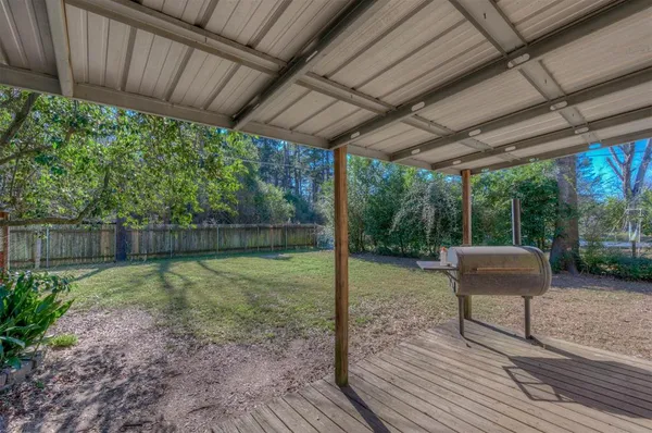 a backyard of a house with table and chairs