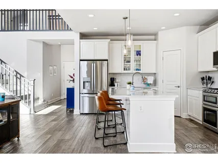 a kitchen with stainless steel appliances kitchen island granite countertop a refrigerator and a stove top oven