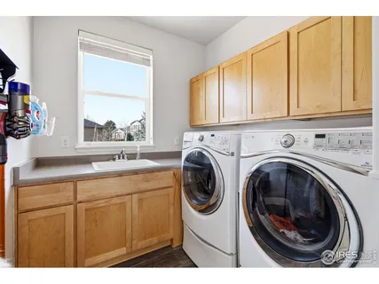 a utility room with sink dryer and washer