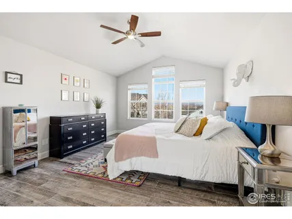 a bedroom with a bed a window and a chandelier