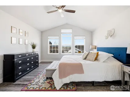 a bedroom with a bed a window and dresser