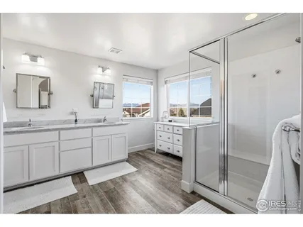 a kitchen with a sink cabinets and wooden floor