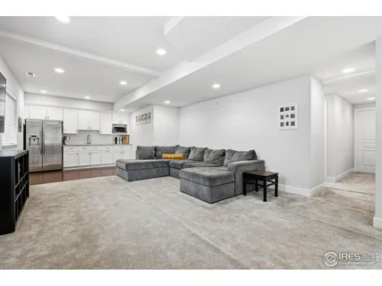 a living room with stainless steel appliances kitchen island furniture and a kitchen view