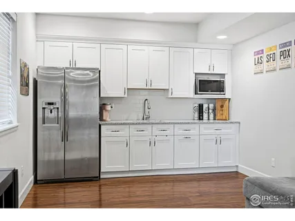 a kitchen with stainless steel appliances granite countertop a refrigerator sink and cabinets