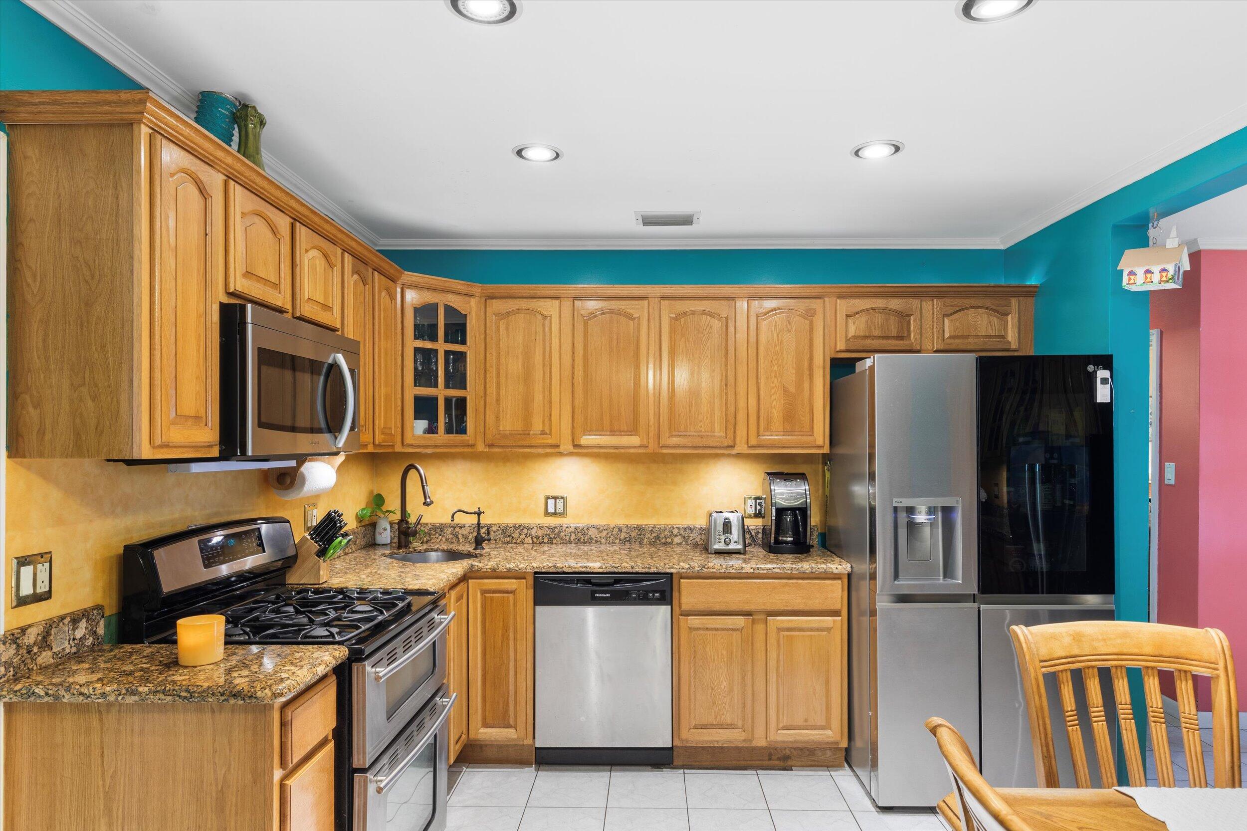 1713 Rose Street Key West, FL 33040 - Photo 27 of 44 a kitchen with stainless steel appliances granite countertop a refrigerator stove and sink