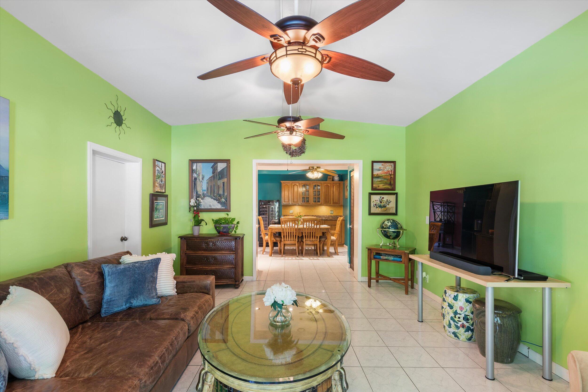 1713 Rose Street Key West, FL 33040 - Photo 32 of 44 a living room with furniture a flat screen tv and a floor to ceiling window